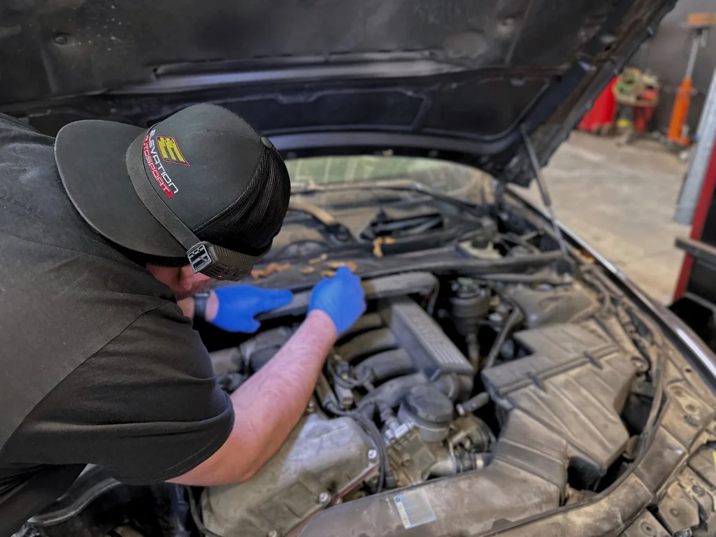 Calgary waste bins help determine the right size for your project while a mechanic repairs an engine